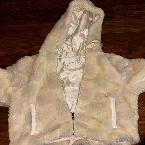 a white faux fur jacket by Anthropologie in size S.